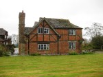 Cousins Farm in The Haven , relatively unspoilt group of old buildings, including barns and converted granary, is a late 2-bay hall house 1500, with chimney 1650 and wing on right C18th. Long association with Ireland family